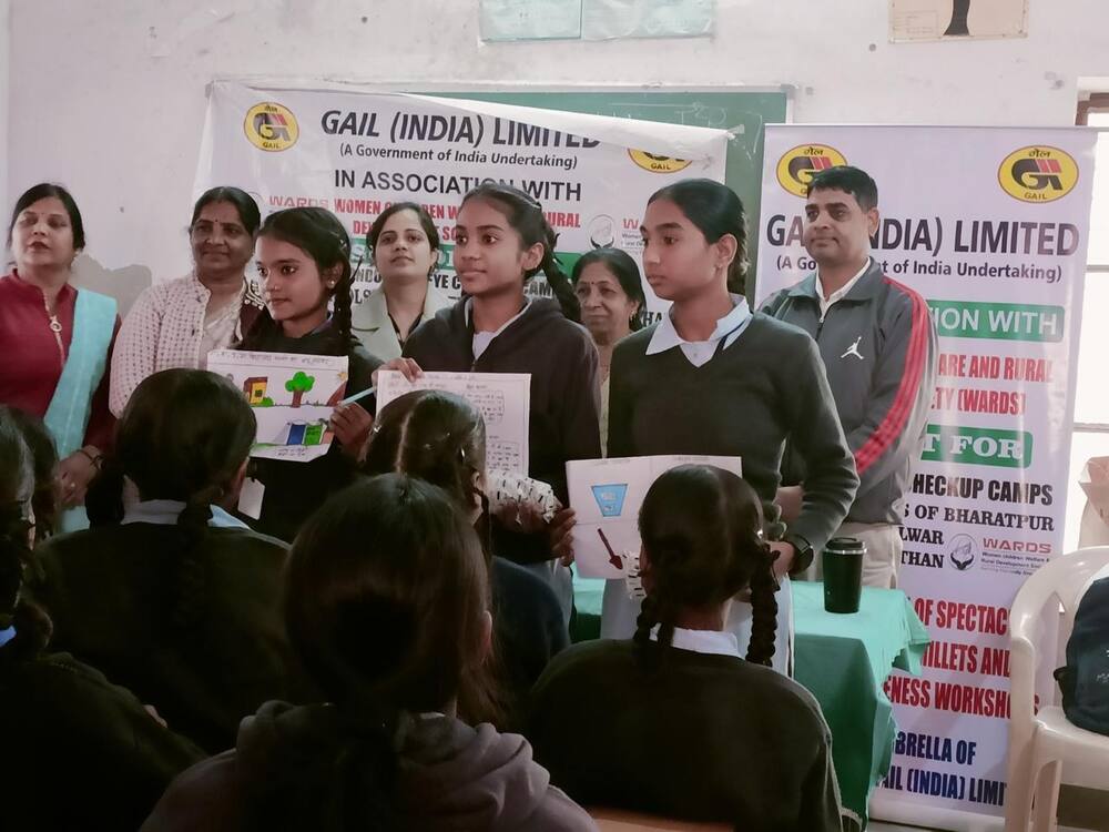 Students presenting hygiene-awareness drawings, Alwar
