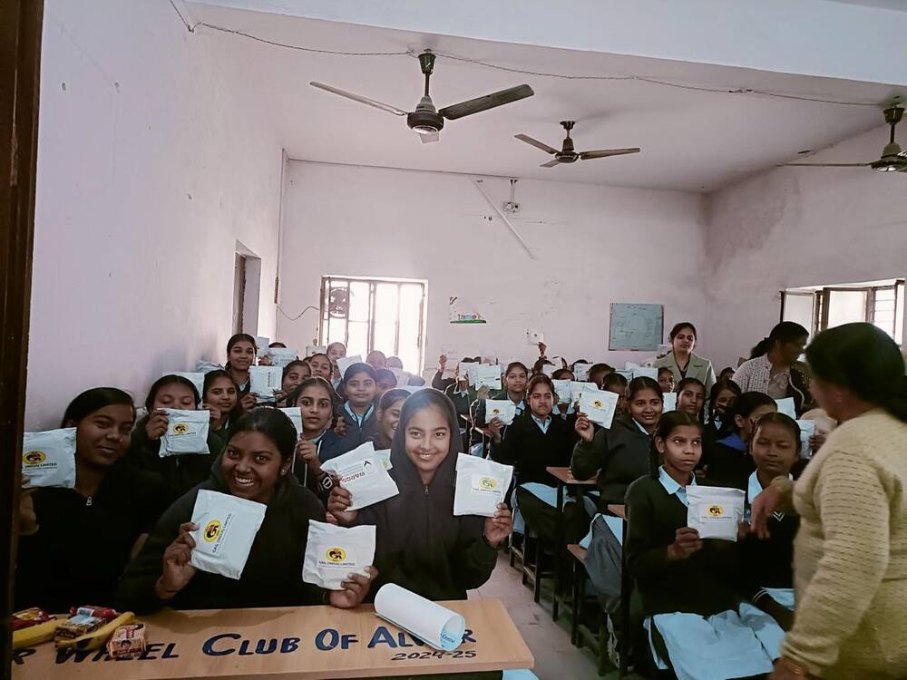 Students holding GAIL-branded sanitary napkin packets, Alwar