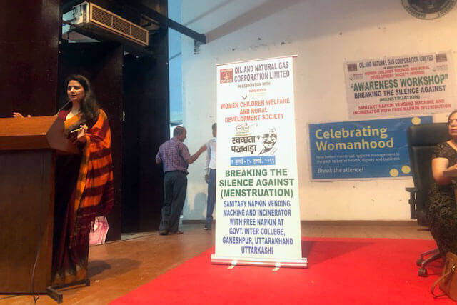 Dr. Shweta Laddha addressing the audience at the podium, Ganeshpur, Uttarkashi