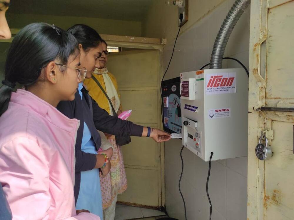 Student using IRCON-WARDS sanitary napkin vending machine