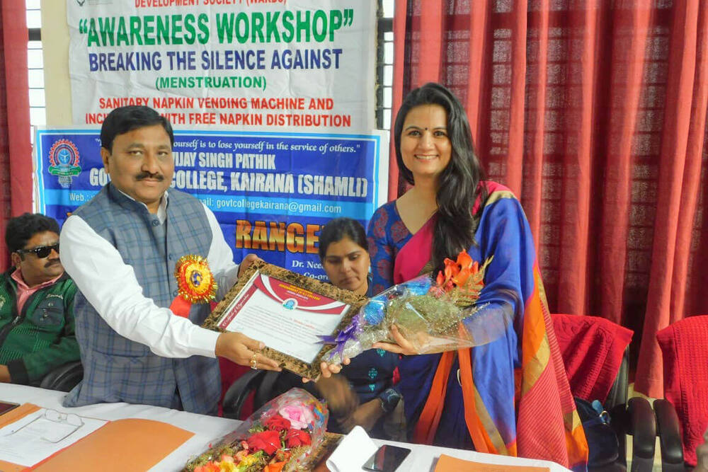 Principal presenting an appreciation citation and flowers to Dr. Shweta Laddha, Kairana
