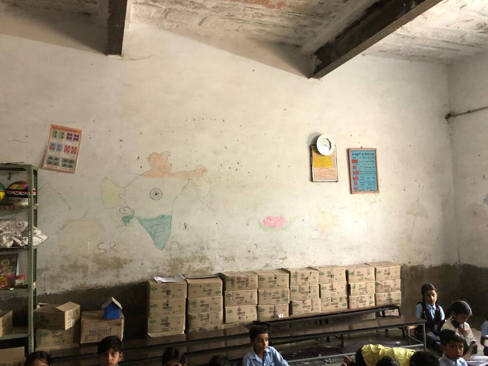 Classroom before renovation — bare walls, no furniture