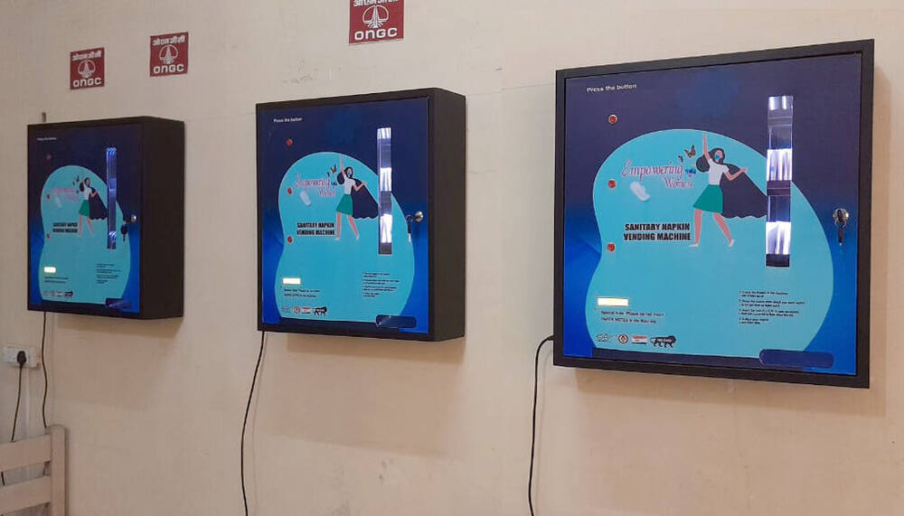Three ONGC-branded sanitary napkin vending machines installed on campus, Anupshahr