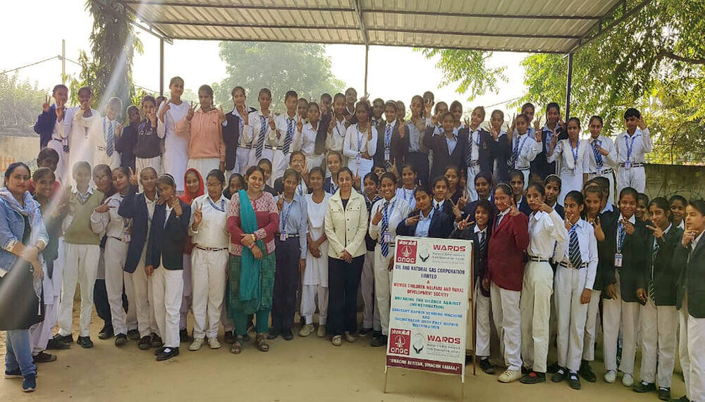 Full student cohort group photo with the ONGC-WARDS campaign banner, Village Pahari