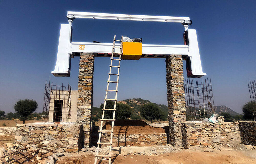 Completed stone-cutting gantry track installed on its stone pillars, Ralawata