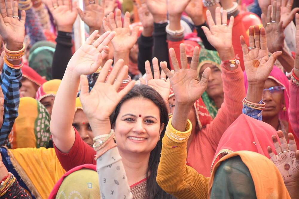 Dr. Shweta Laddha with the crowd, hands raised, Skill Development Centre opening, Ralawata