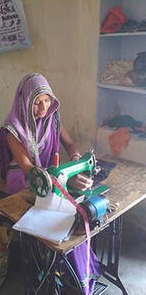 Asha Lakhara at her sewing machine, cropped from WARDS' programme report