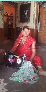 Komal Vaishnav at her sewing machine, cropped from WARDS' programme report