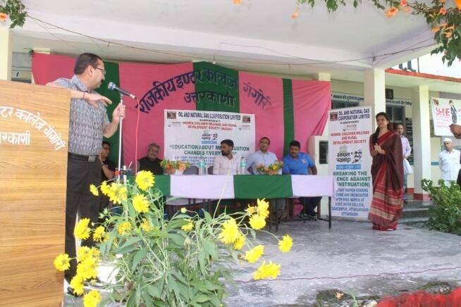 Launch ceremony stage with dignitaries, ONGC-WARDS menstrual hygiene project, Ganeshpur, Uttarkashi, 15 Jul 2019